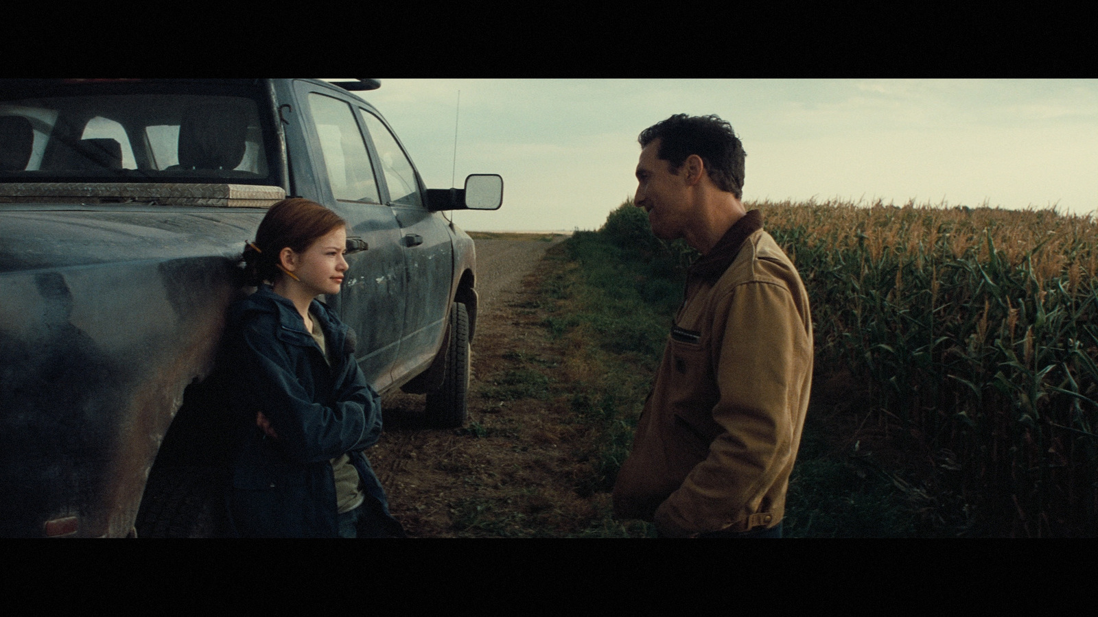 a man and a woman standing next to a truck