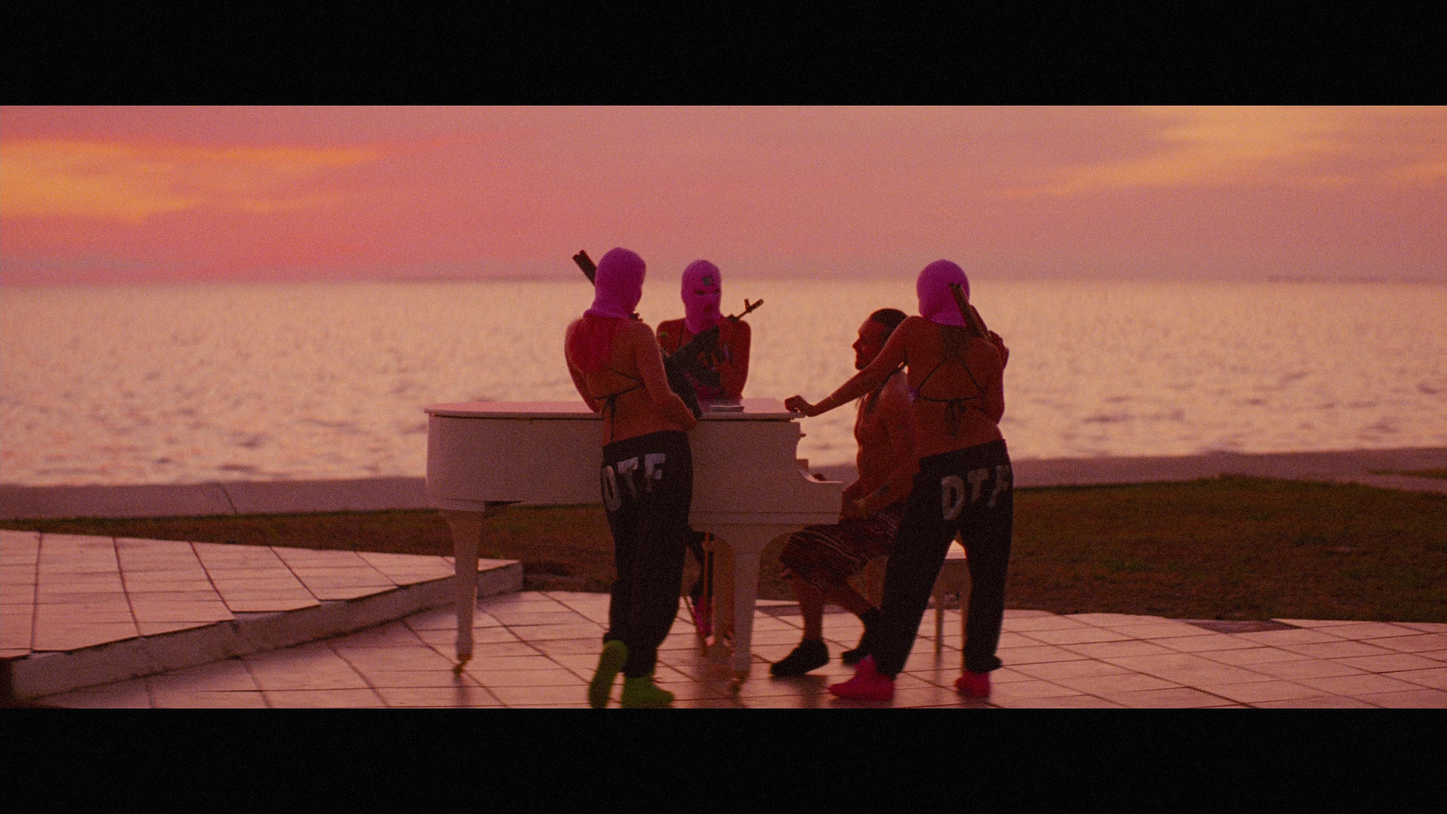 a group of people that are standing around a piano