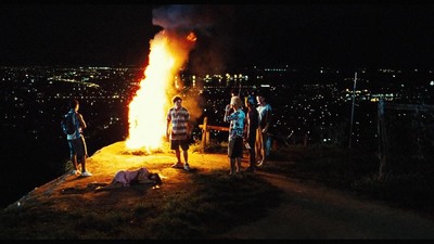 a group of people standing around a fire