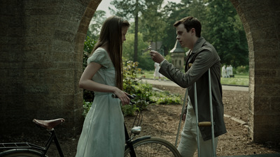 a man standing next to a woman near a bike