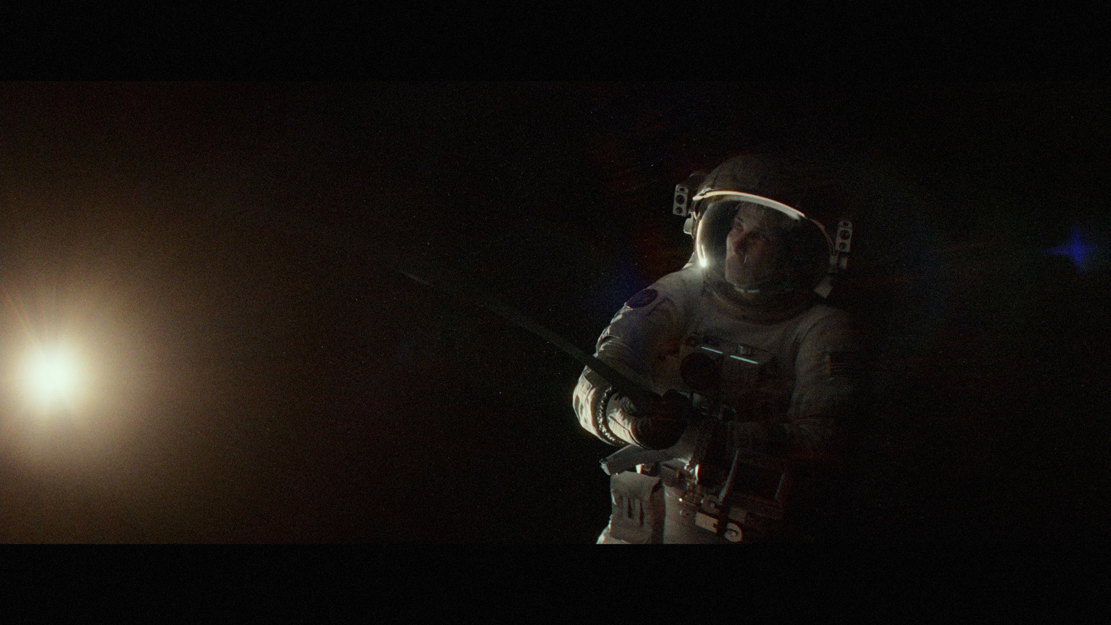 a man in a space suit holding a rifle