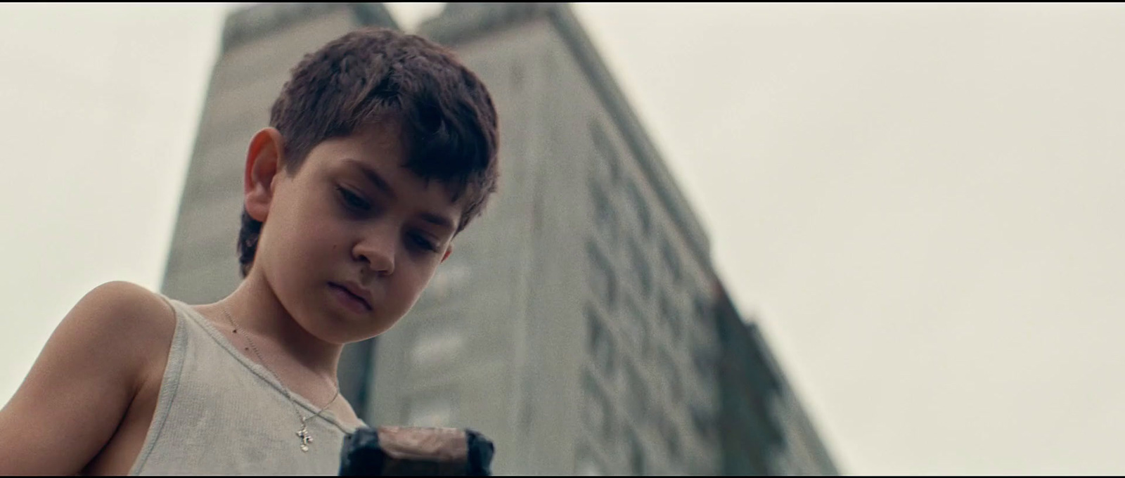 a young boy looking at his cell phone