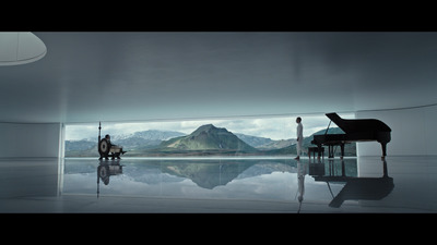 a person sitting at a piano in a room