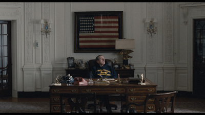 a man sitting at a desk in a room