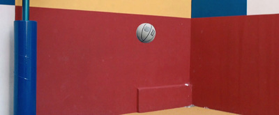 a red, yellow, and blue room with a white ball