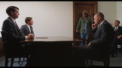 a group of men sitting around a wooden table