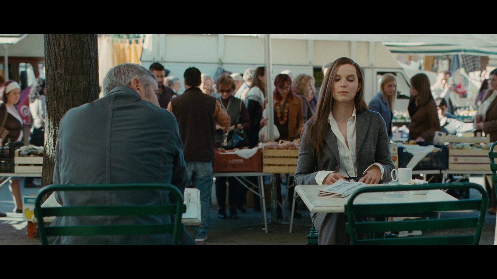 a woman sitting at a table in front of a man