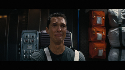 a man standing in front of a stack of luggage