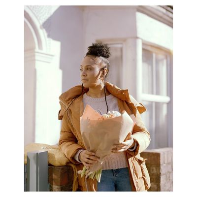 a woman holding a bouquet of flowers in her hands