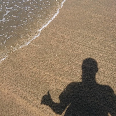 a shadow of a person on a beach