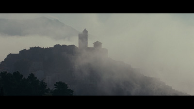 a castle on a hill surrounded by fog