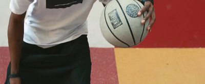 a person holding a basketball in their hand