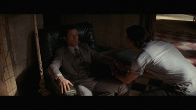 a man sitting in a chair next to a woman