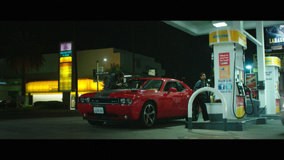 a red car at a gas station at night