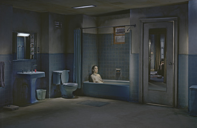 a woman sitting in a bathtub in a bathroom