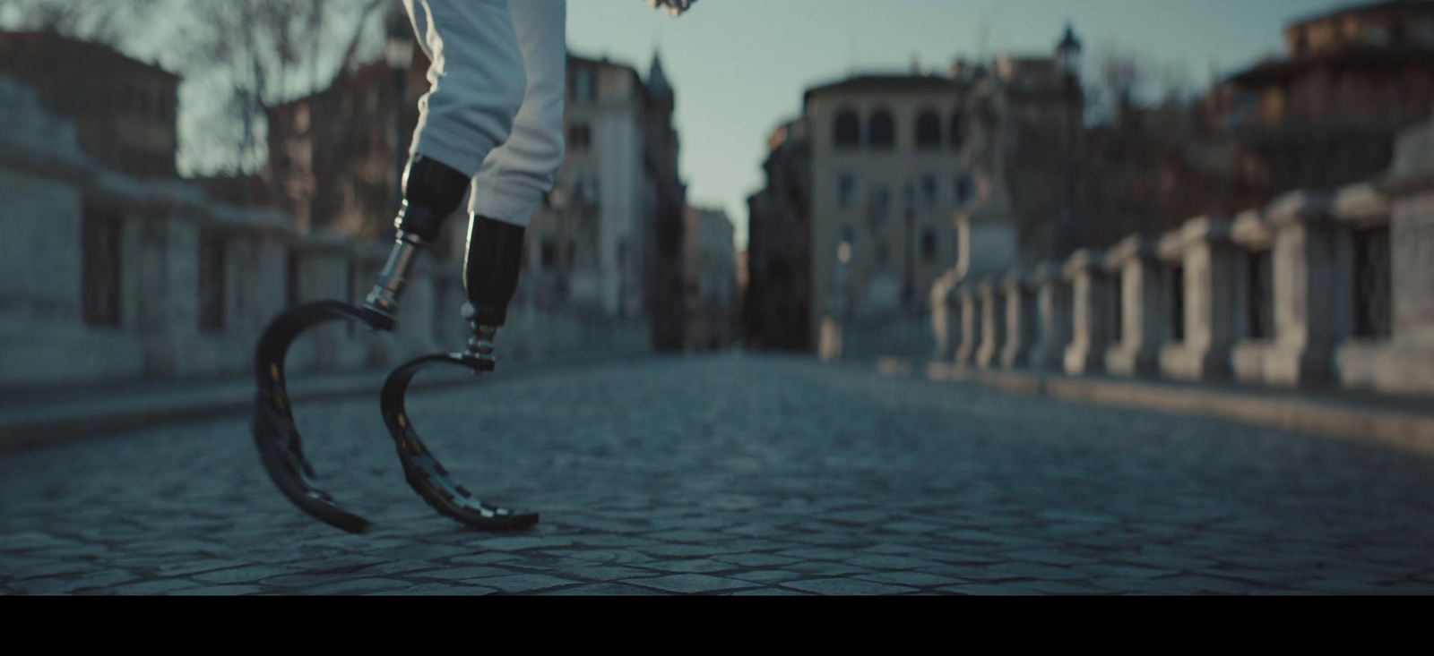 a person riding a scooter on a cobblestone street