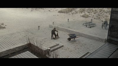 a couple of people that are standing in the sand