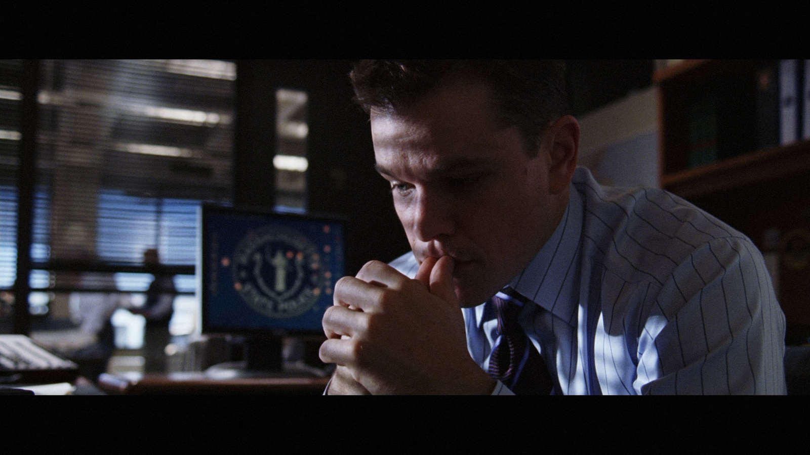 a man sitting at a desk in front of a computer