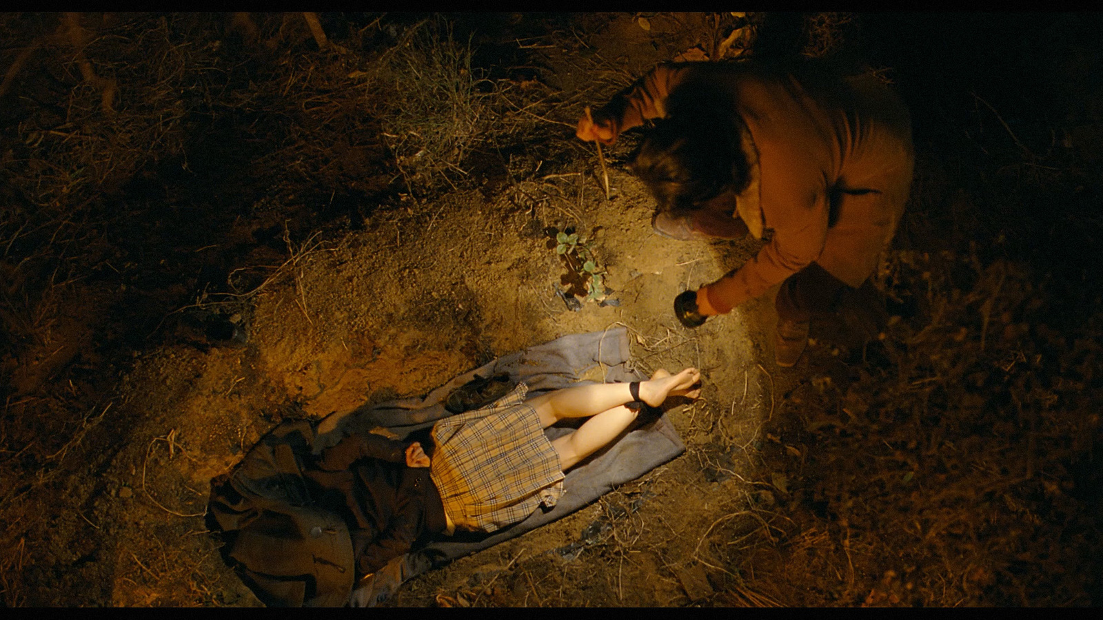 a person laying on the ground next to a backpack