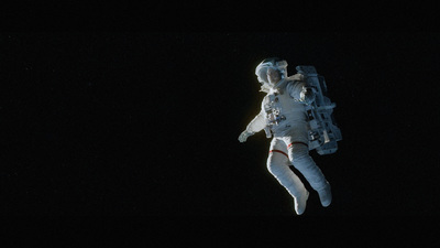 a man in a space suit floating in the air