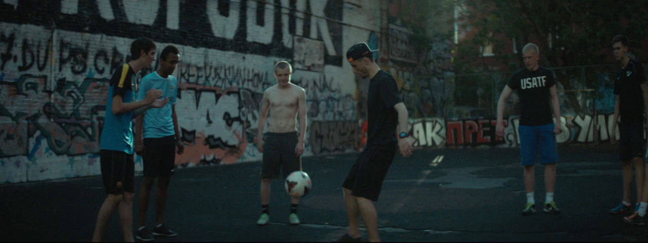 a group of men standing around a soccer ball