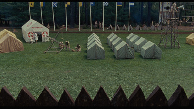 a group of tents sitting on top of a lush green field