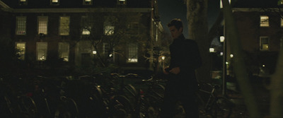 a man standing next to a bunch of bikes