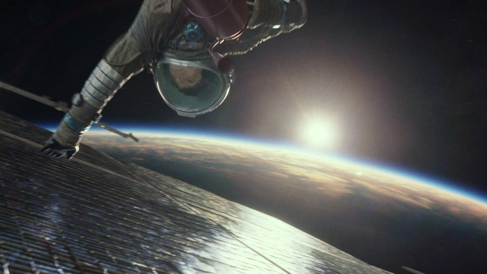 a man in a spacesuit floating above the earth