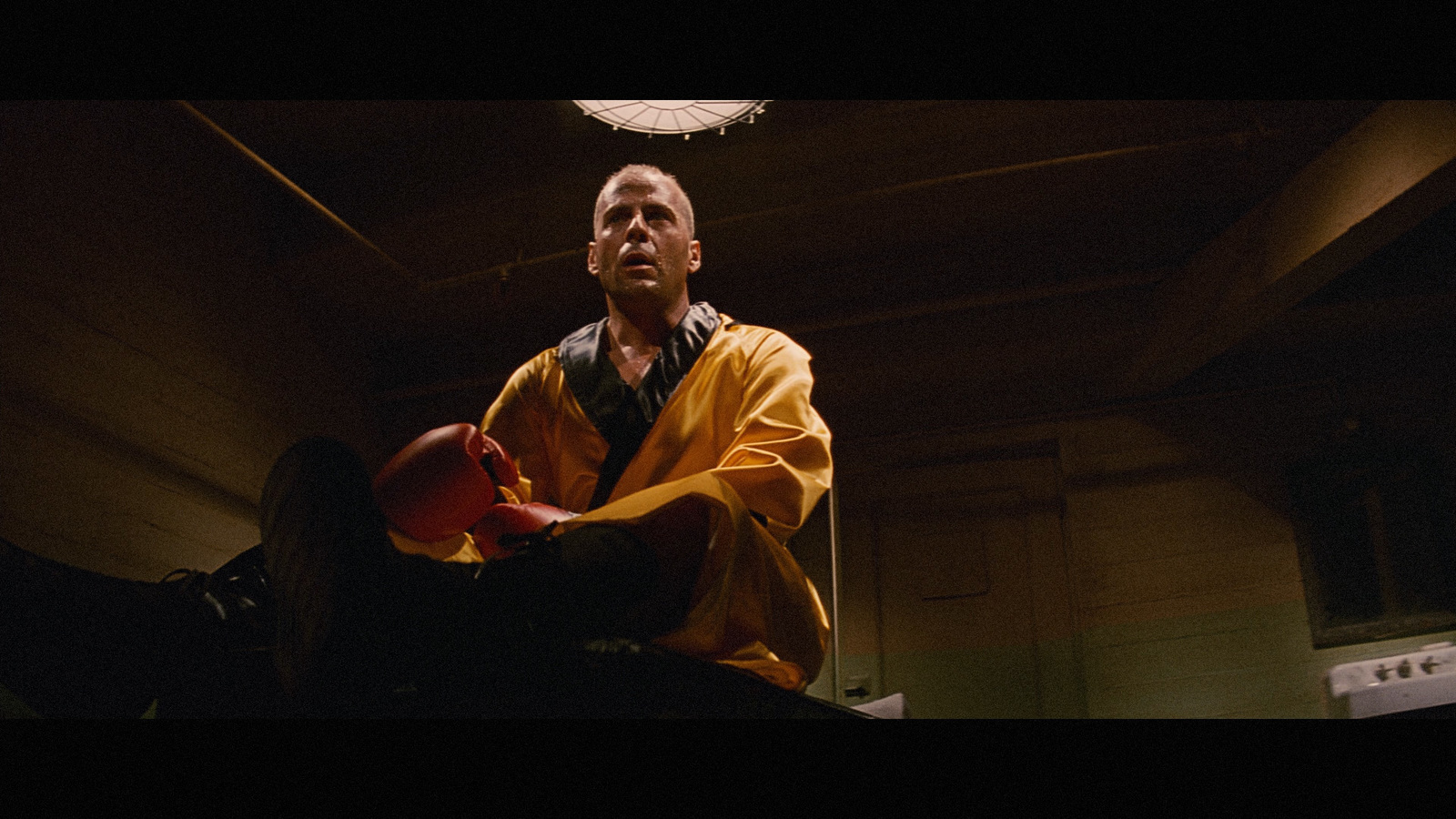 a man in a yellow raincoat holding a red object