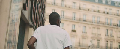 a man standing in front of a tall building