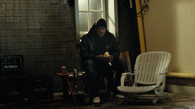 a man sitting in a chair next to a window