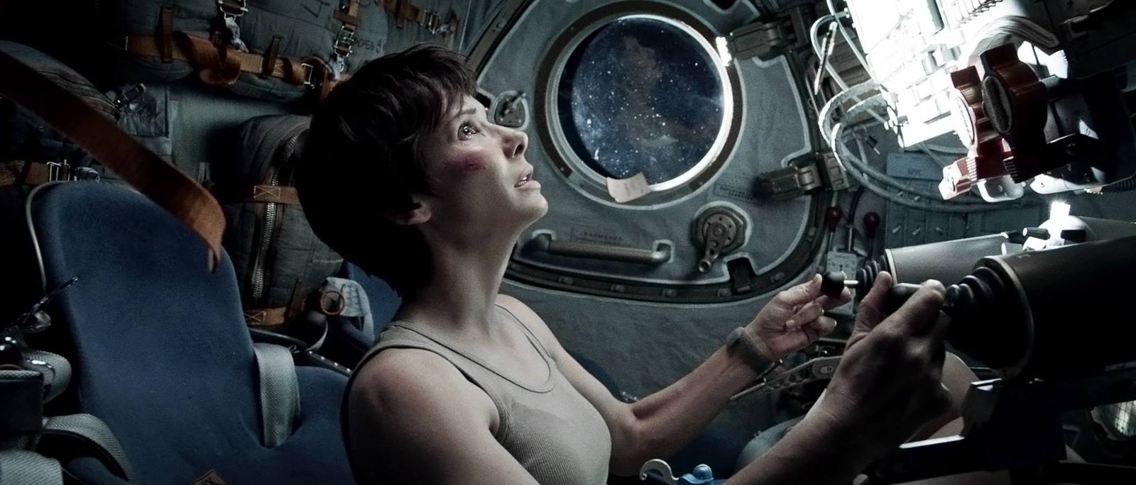 a woman in a space station looking up into the sky