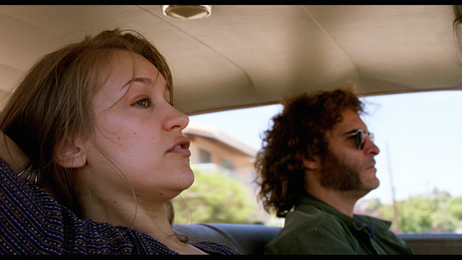 a man and a woman sitting in a car