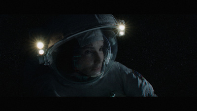 a man in a space suit with two lights on his head