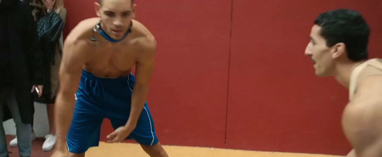 a man standing next to another man on a basketball court