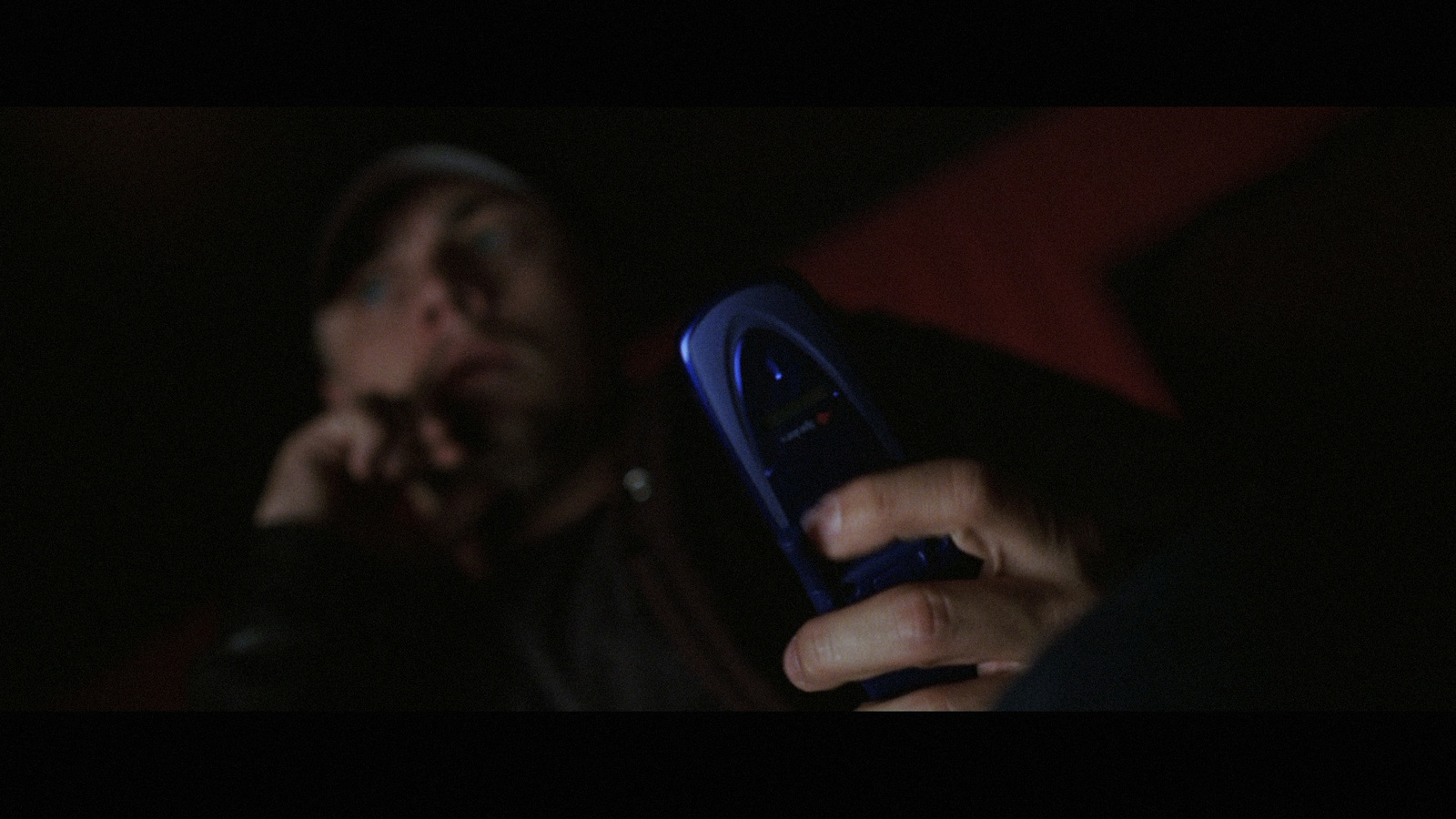 a person holding a cell phone in their hand