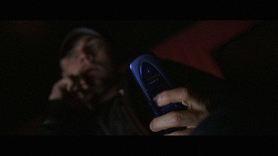 a person holding a cell phone in their hand