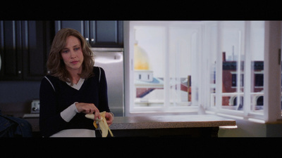 a woman holding a banana in a kitchen