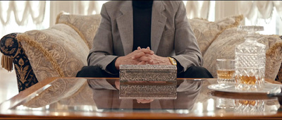 a man in a suit sitting at a table