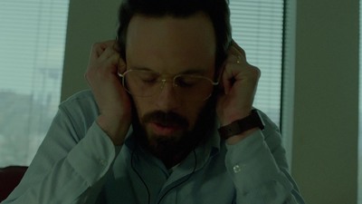 a man with glasses and a beard wearing headphones