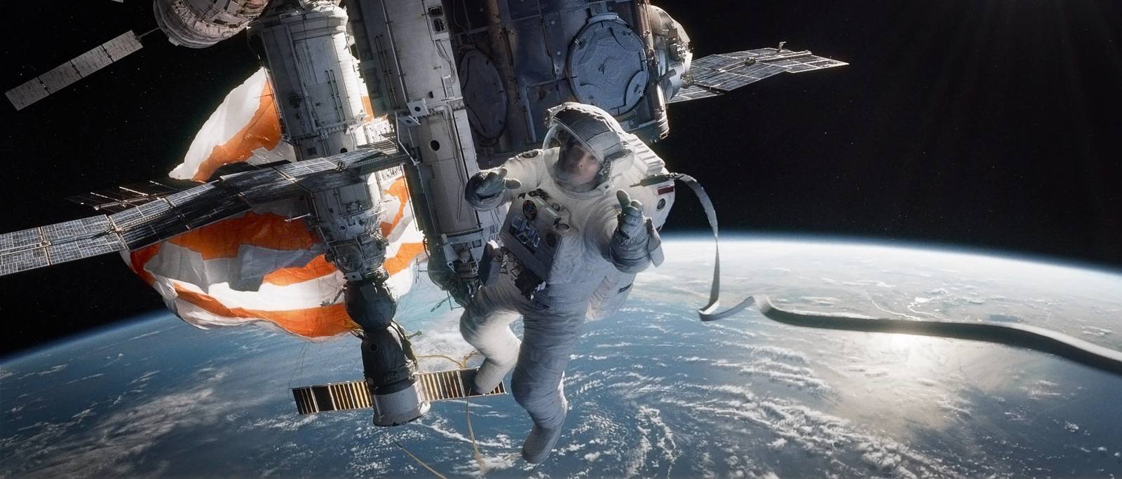 a man in a spacesuit floating above the earth