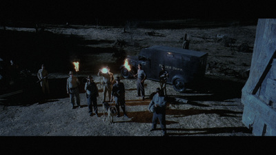 a group of people standing around a truck