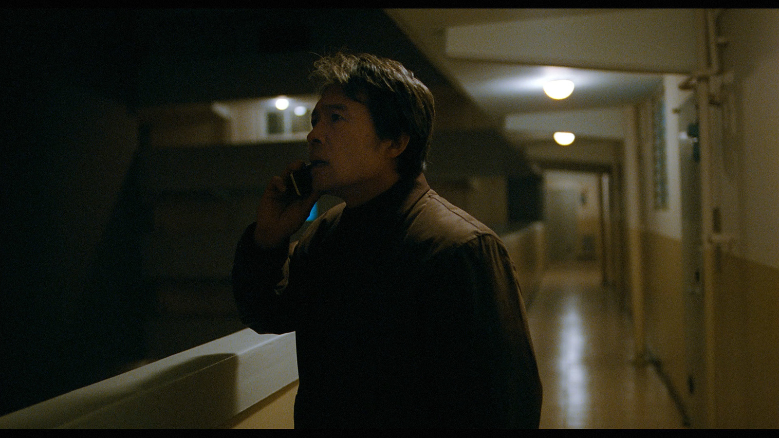 a man standing in a hallway with a toothbrush in his mouth