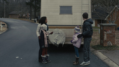 a couple of people standing in front of a truck