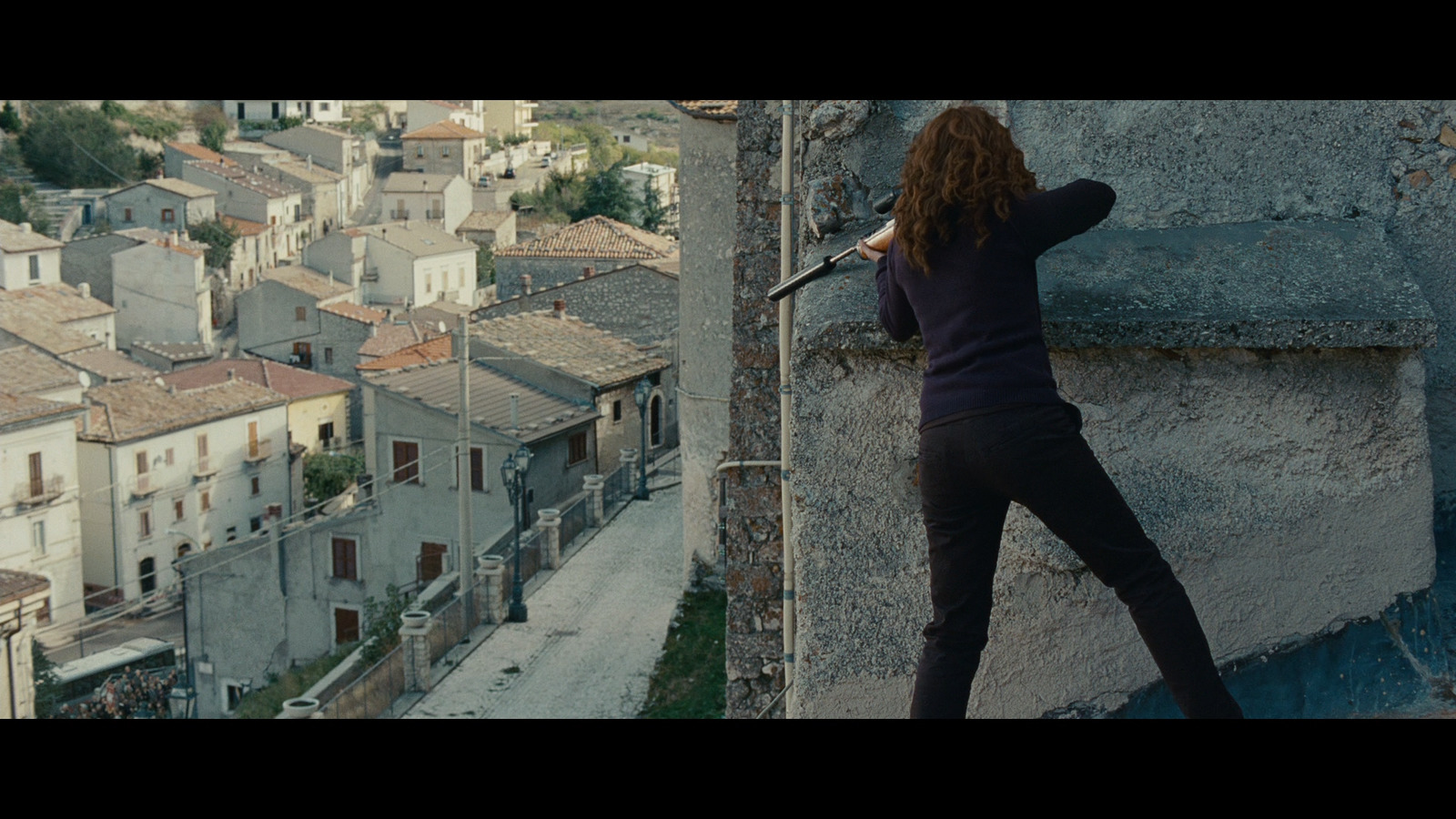 a woman is climbing up a stone wall