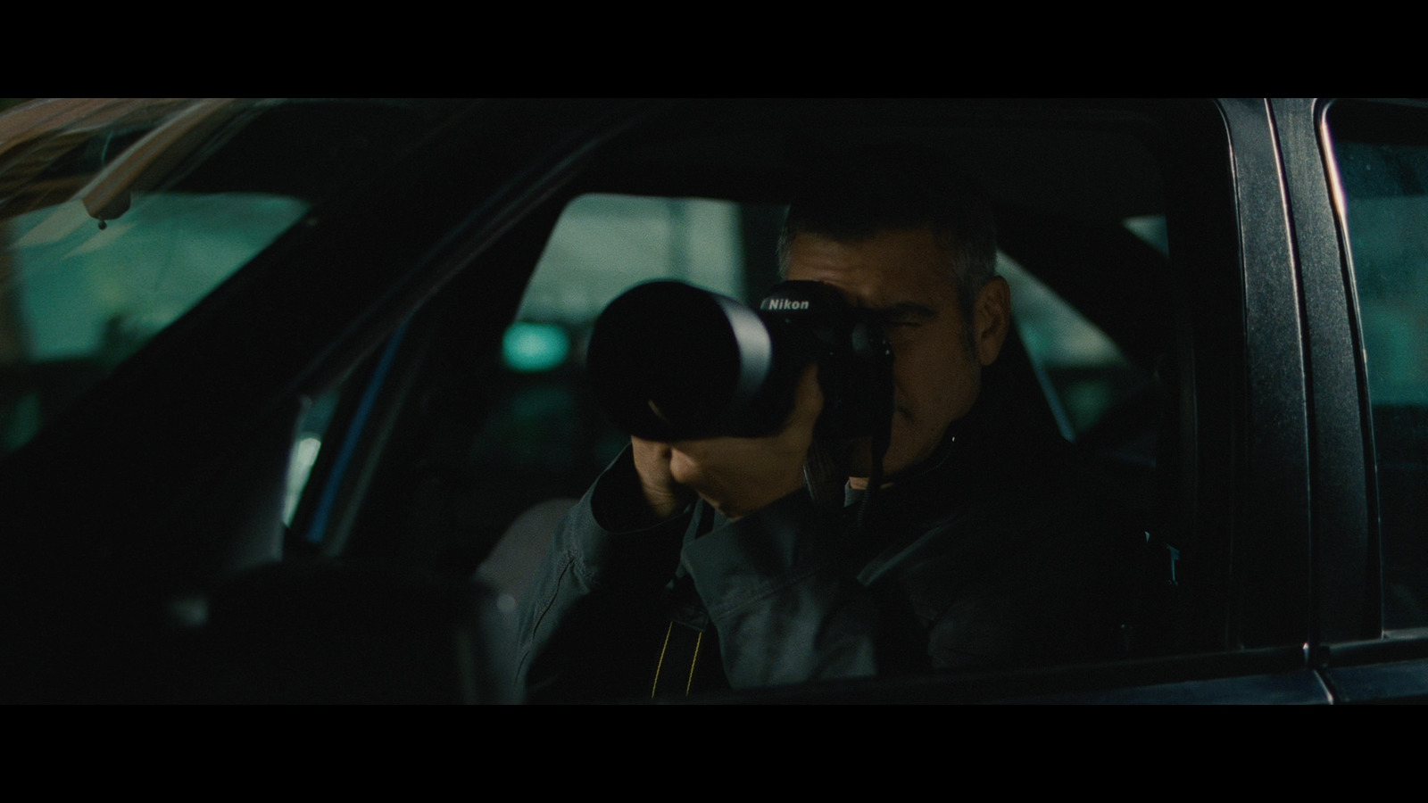 a man taking a picture of himself in a car