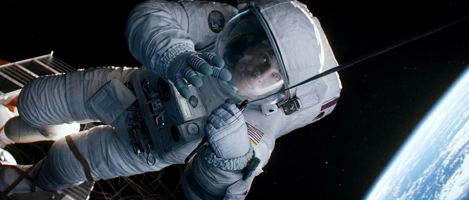 a man in a spacesuit in front of the earth