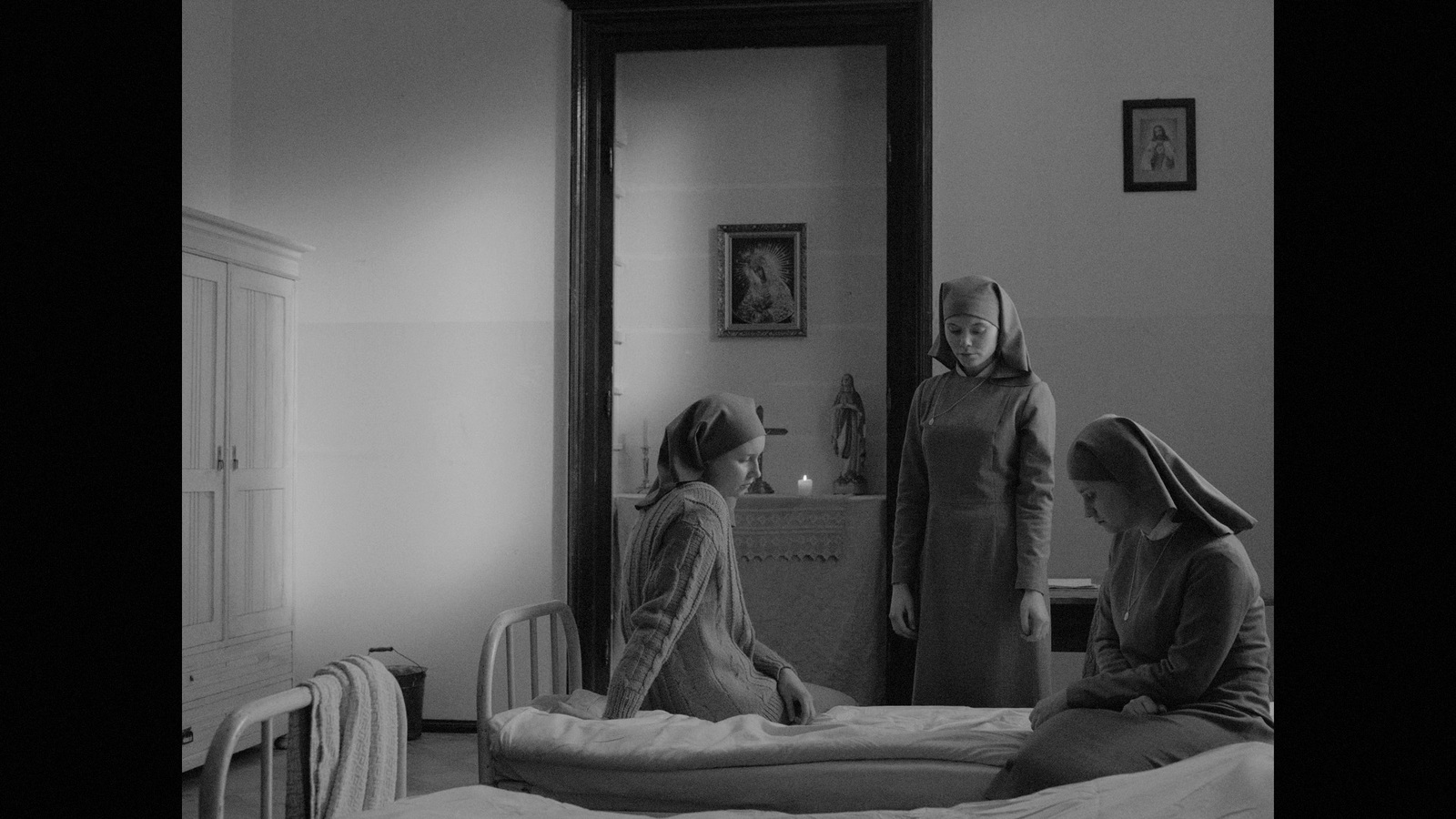 a black and white photo of two women in a bedroom