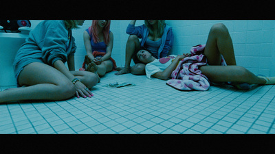 a group of women sitting on the floor in a bathroom