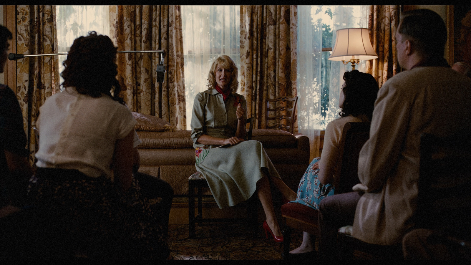 a group of women sitting around a living room together